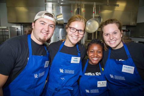 4 individuals in blue aprons with the UK CES logo